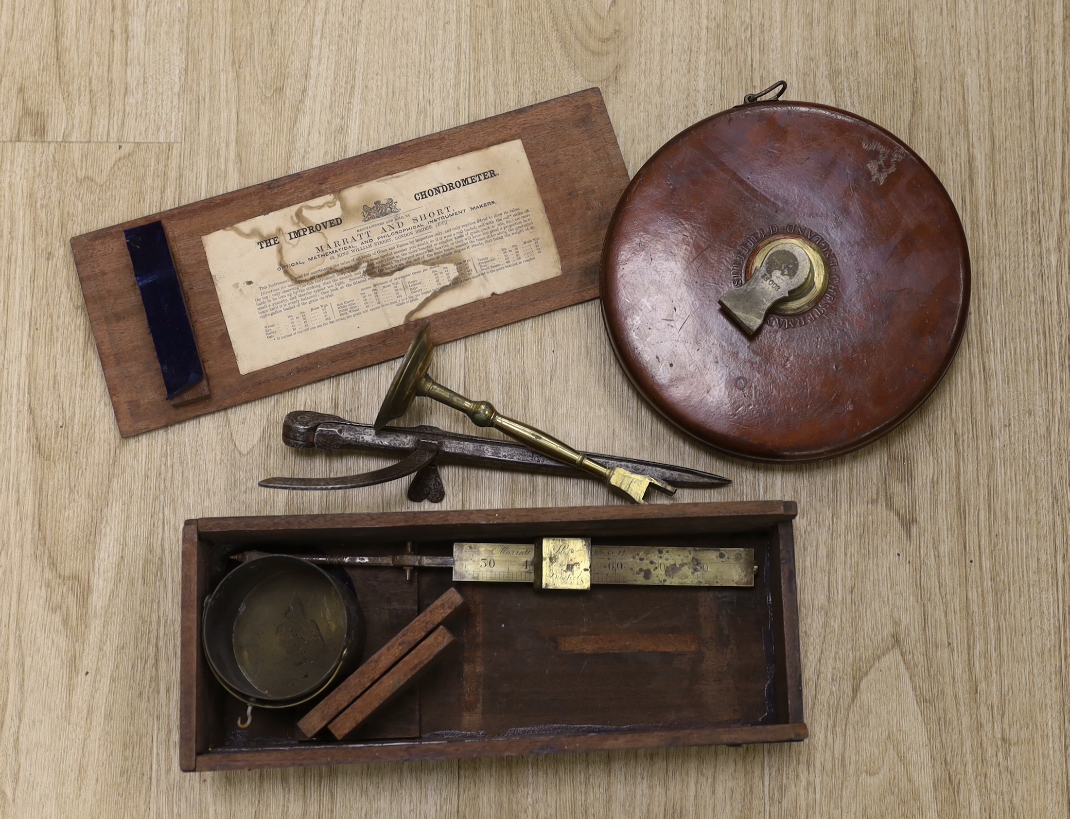 A late Georgian Marratt & Short Improved Chondrometer, a large surveyor's measure and a cast iron protractor